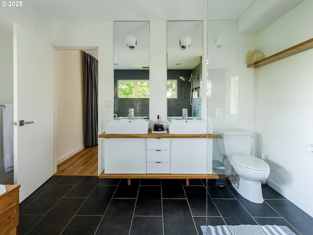 full bathroom featuring a sink, toilet, and double vanity