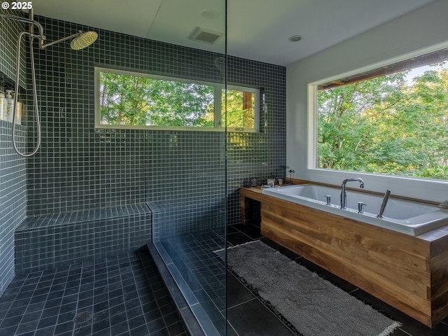 bathroom with visible vents, a tile shower, a bath, and tile patterned floors