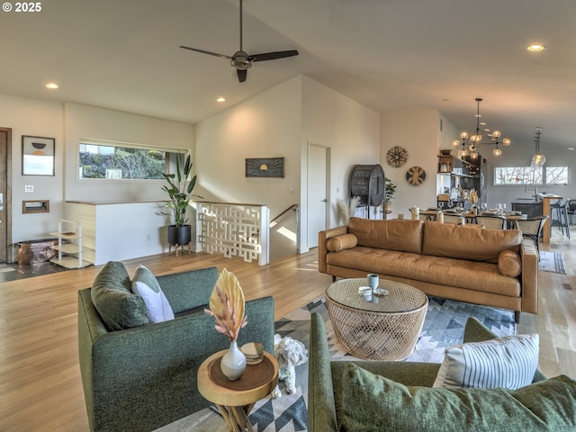 living area with lofted ceiling, wood finished floors, and recessed lighting