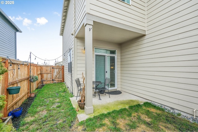 doorway to property featuring a patio and a yard