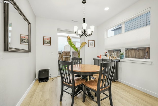 dining room featuring light hardwood / wood-style floors and a chandelier