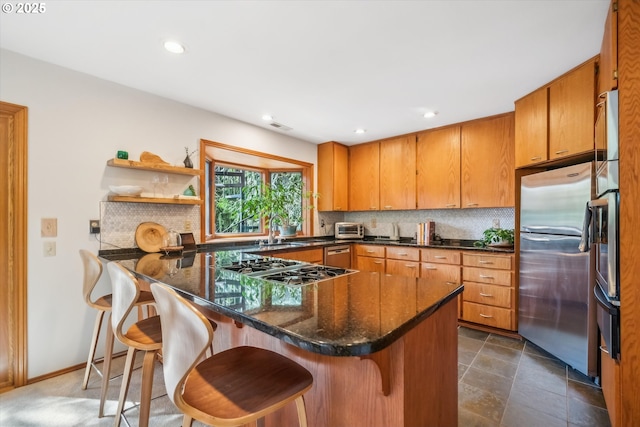 13305 Fox Run, Lake Oswego, OR 97034 - kitchen with stainless steel appliances, backsplash, a peninsula, brown cabinetry, and recessed lighting