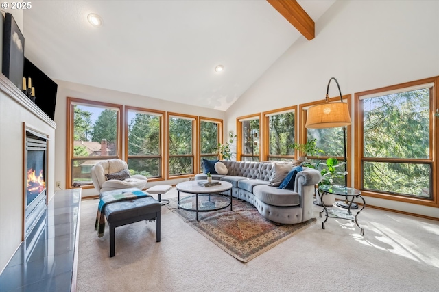 carpeted living area with recessed lighting, beam ceiling, high vaulted ceiling, and a glass covered fireplace