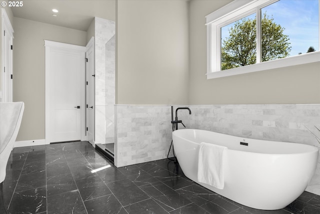 15007 Twin Fir Rd, Lake Oswego, OR 97035 - bathroom featuring tile walls, marble finish flooring, a soaking tub, a wainscoted wall, and recessed lighting