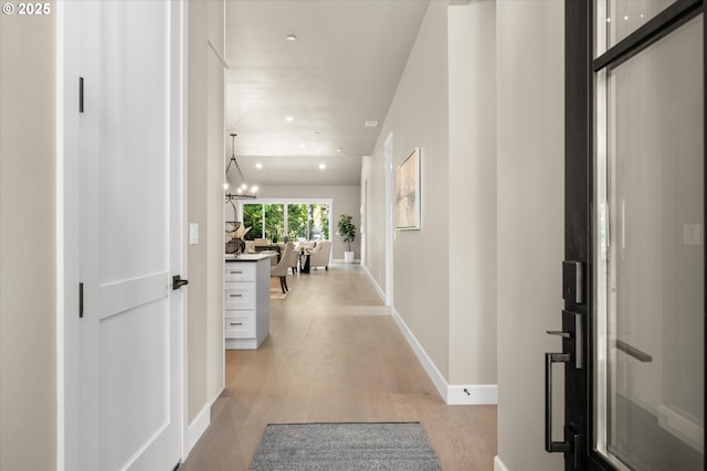 15007 Twin Fir Rd, Lake Oswego, OR 97035 - corridor with light wood-style flooring, recessed lighting, and a chandelier