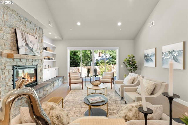 15007 Twin Fir Rd, Lake Oswego, OR 97035 - living area featuring high vaulted ceiling, light wood-style floors, a stone fireplace, and recessed lighting