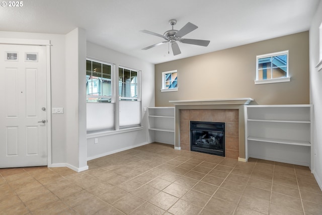 unfurnished living room featuring a tile fireplace, ceiling fan, and light tile patterned floors