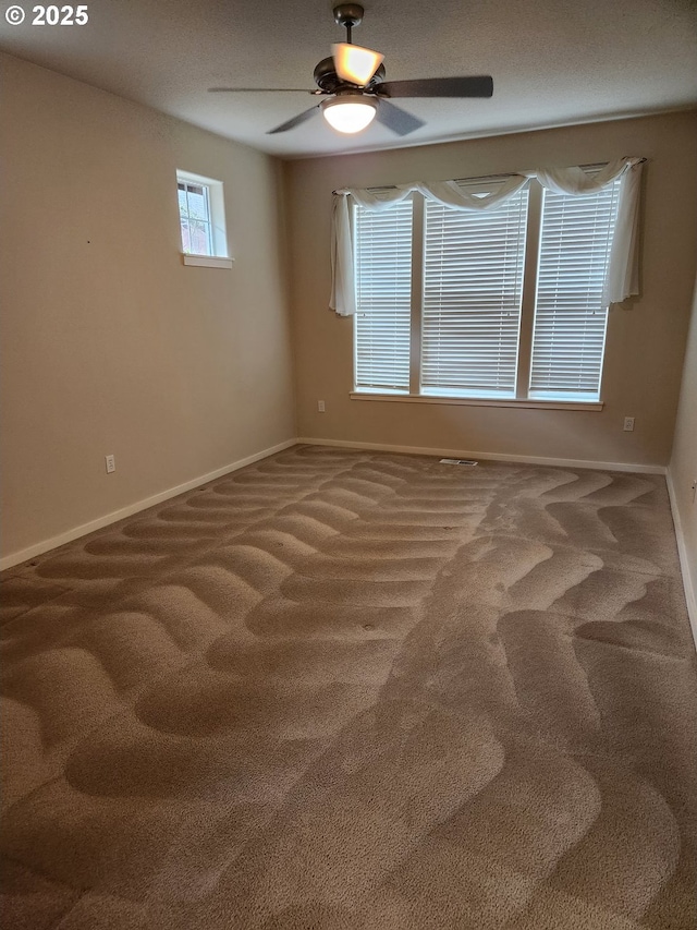 spare room with ceiling fan and carpet flooring