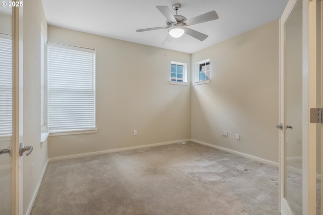 carpeted empty room featuring ceiling fan