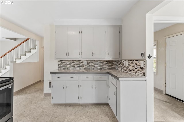 4004 SE 97th, Portland, OR 97266 - kitchen with tasteful backsplash, stainless steel electric range oven, white cabinetry, and baseboards