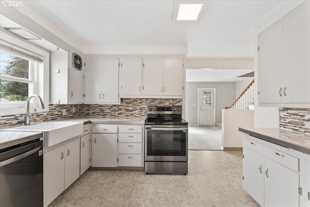 4004 SE 97th, Portland, OR 97266 - kitchen featuring appliances with stainless steel finishes, backsplash, light countertops, and a sink