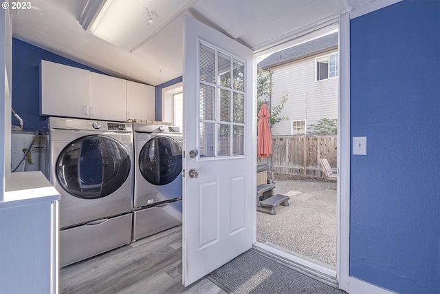 1060 SW 206th Ave, Beaverton, OR 97003 - laundry area with cabinet space, a textured wall, washing machine and dryer, and wood finished floors