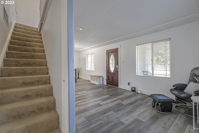 1060 SW 206th Ave, Beaverton, OR 97003 - entryway with a textured ceiling, visible vents, wood finished floors, stairway, and baseboards