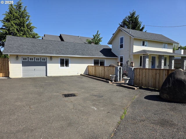 1060 SW 206th Ave, Beaverton, OR 97003 - view of front of home with an attached garage, fence, and aphalt driveway