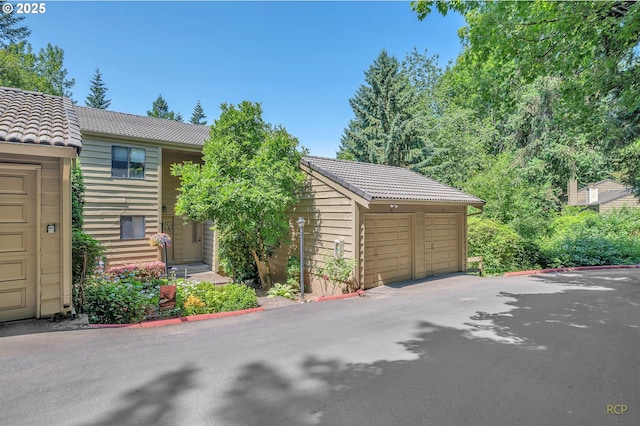 50 Cervantes Cir, Lake Oswego, OR 97035 - view of front of house featuring a tile roof and a detached garage