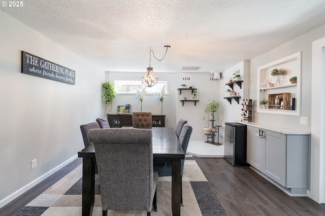 3141 SW 176th Ave, Beaverton, OR 97003 - dining area with dark wood finished floors, a textured ceiling, and a chandelier