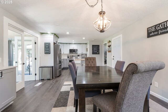 3141 SW 176th Ave, Beaverton, OR 97003 - dining area featuring wood finished floors, a chandelier, recessed lighting, and a textured ceiling