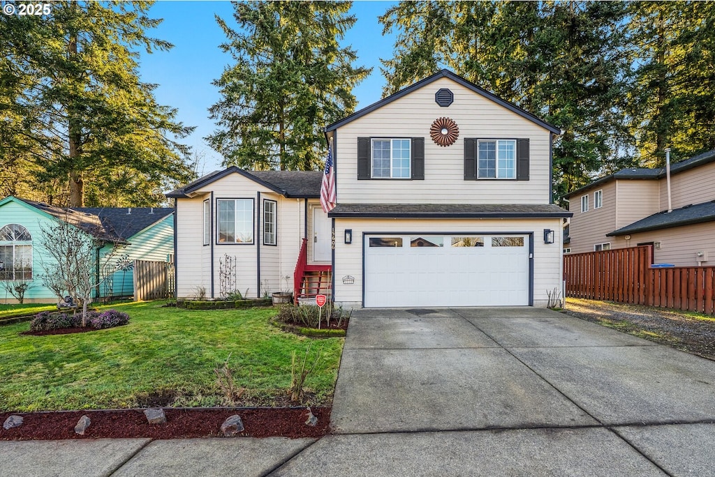 view of front of house featuring a garage and a front lawn