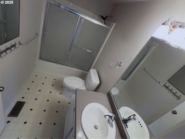 3880 SW 194th Pl, Beaverton, OR 97078 - bathroom featuring toilet, vanity, tile patterned floors, baseboards, and bath / shower combo with glass door