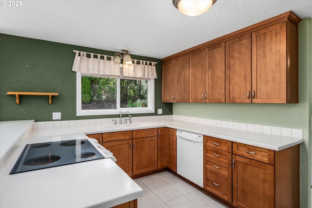 3985 Donald St, Eugene, OR 97405 - kitchen featuring dishwasher, a sink, brown cabinets, and a textured ceiling