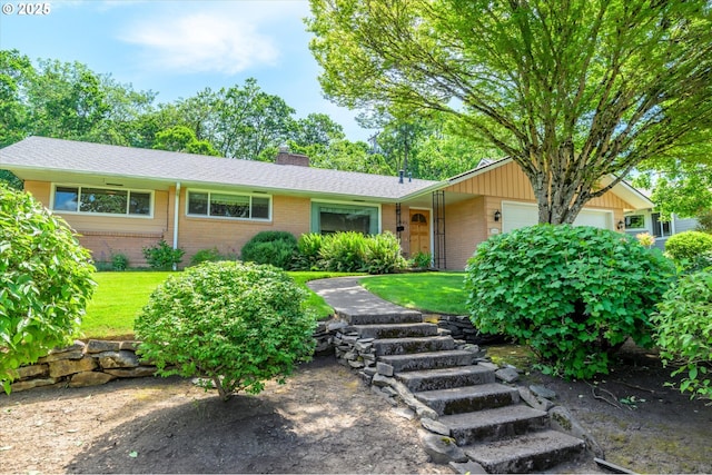 3985 Donald St, Eugene, OR 97405 - ranch-style home featuring brick siding, a garage, a chimney, and a front lawn