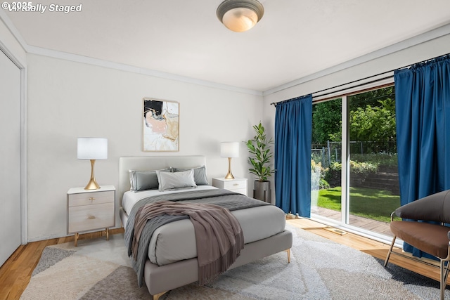 3985 Donald St, Eugene, OR 97405 - bedroom featuring wood finished floors, crown molding, and access to exterior