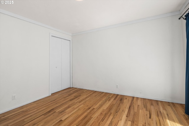 3985 Donald St, Eugene, OR 97405 - unfurnished bedroom with wood finished floors, a closet, crown molding, and baseboards