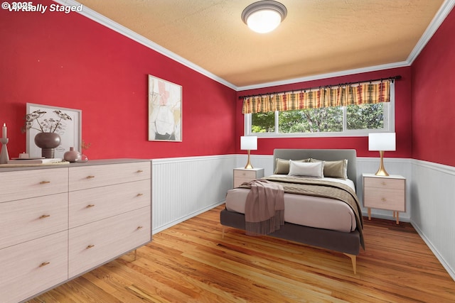3985 Donald St, Eugene, OR 97405 - bedroom with a wainscoted wall, light wood-type flooring, a textured ceiling, and ornamental molding
