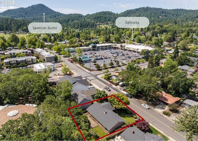 3985 Donald St, Eugene, OR 97405 - aerial overview of property's location with a heavily wooded area, property boundaries highlighted, and a mountain backdrop