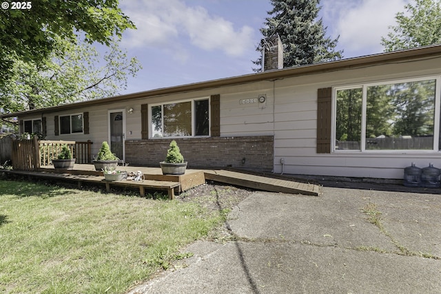 4805 NE 122nd Ave, Vancouver, WA 98682 - ranch-style home with a deck, a chimney, a front lawn, and brick siding