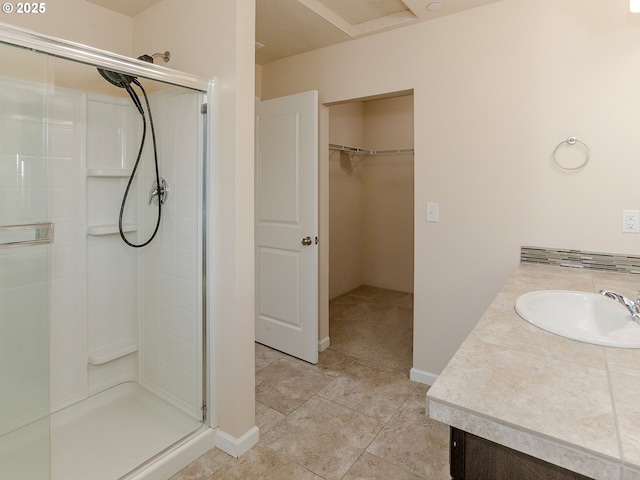 7417 N 92nd Ave, Camas, WA 98607 - full bathroom featuring a stall shower, a walk in closet, vanity, and tile patterned floors