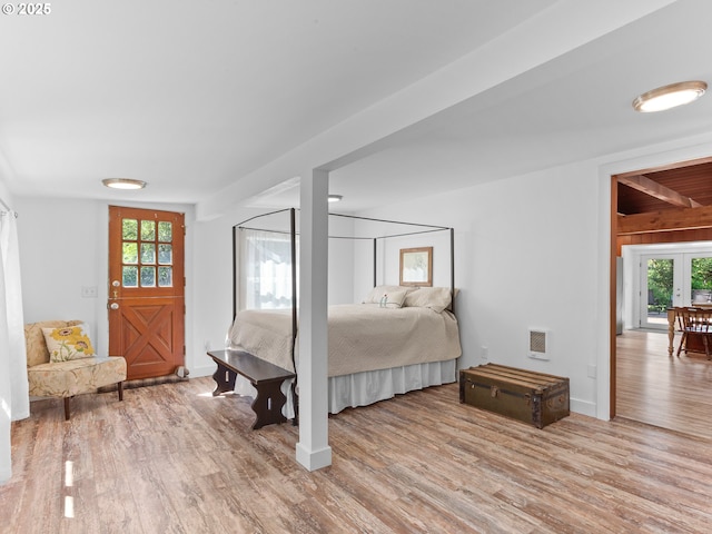 bedroom with baseboards and wood finished floors