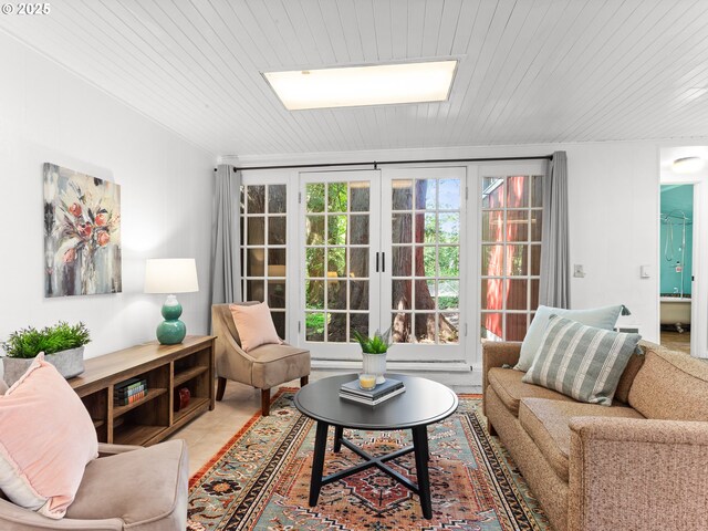 living room with a skylight, wood ceiling, and light tile patterned floors