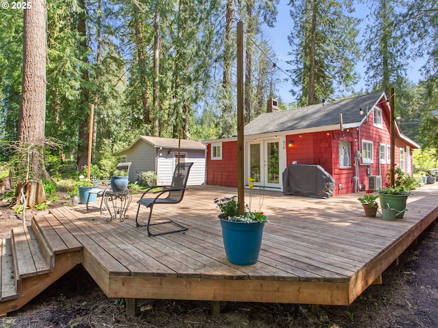 deck featuring cooling unit, french doors, and a grill