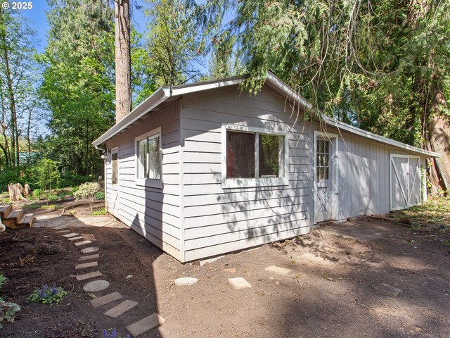 view of property exterior with an outdoor structure