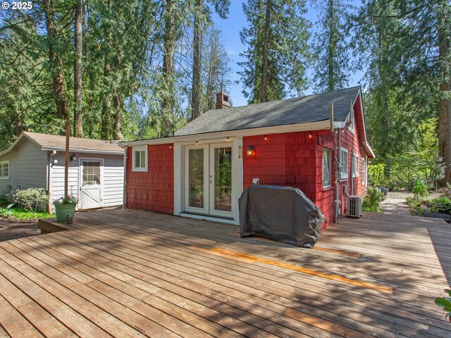 wooden terrace featuring area for grilling and french doors