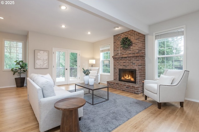 living room with recessed lighting, a healthy amount of sunlight, and wood finished floors