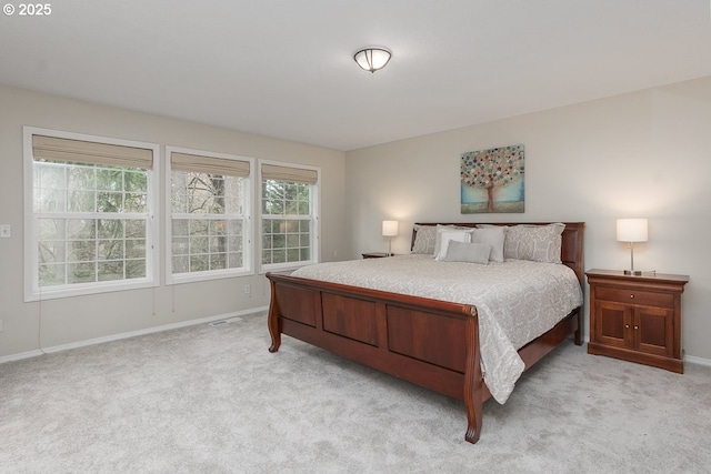 bedroom featuring baseboards and light carpet