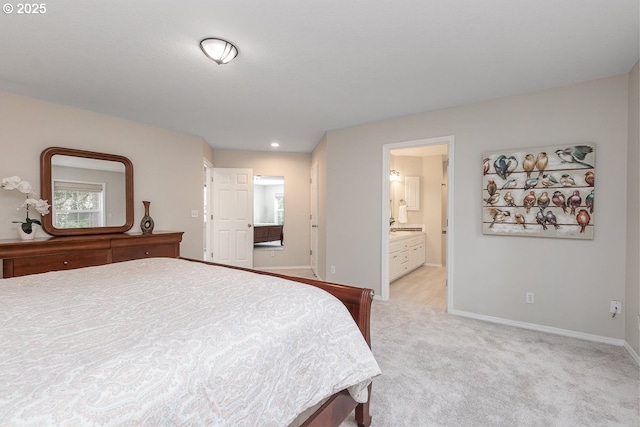 bedroom with light colored carpet, baseboards, and connected bathroom