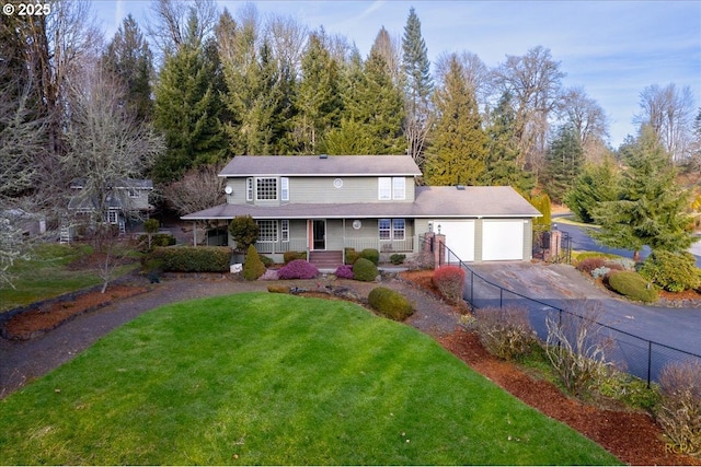 view of property with a garage, a front yard, and covered porch