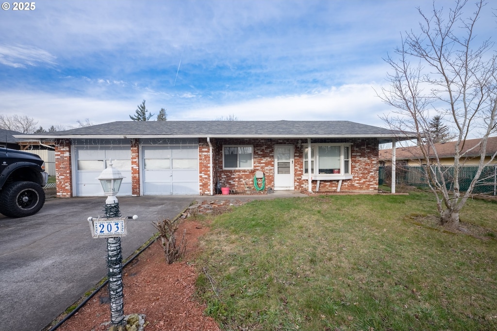 ranch-style home with a garage and a front yard