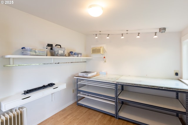 2880 Prospect Ave, Hood River, OR 97031 - miscellaneous room featuring radiator heating unit, light wood-type flooring, a wall mounted air conditioner, and baseboards