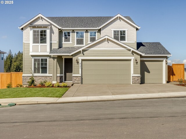 craftsman-style home featuring a shingled roof, fence, stone siding, and concrete driveway