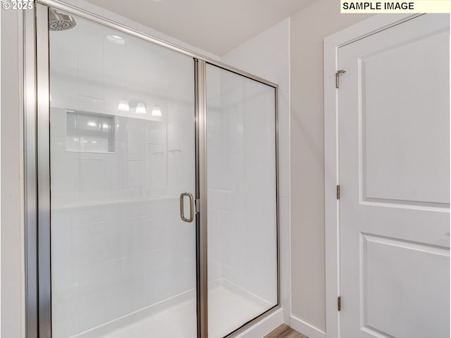 bathroom with a shower with shower door