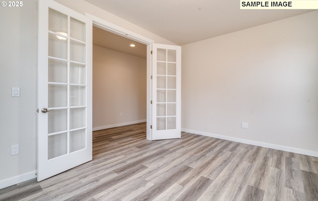 unfurnished room with recessed lighting, french doors, baseboards, and wood finished floors