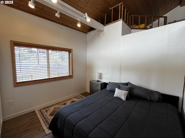 bedroom featuring wood ceiling, track lighting, baseboards, and dark wood-style flooring