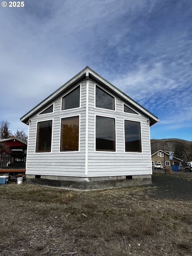 view of property exterior with crawl space