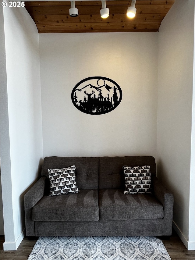 living room featuring wooden ceiling, baseboards, and dark wood finished floors