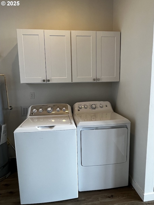 laundry area with baseboards, cabinet space, dark wood finished floors, and washing machine and clothes dryer