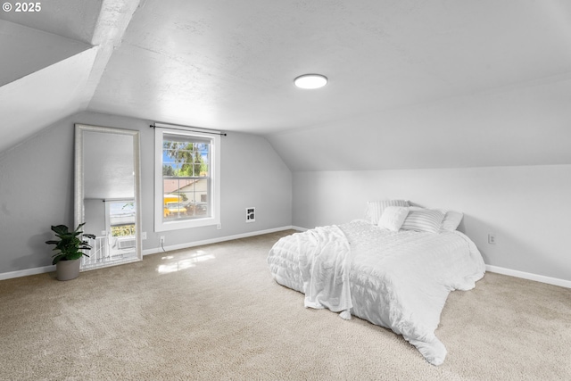 bedroom featuring carpet floors, baseboards, and vaulted ceiling